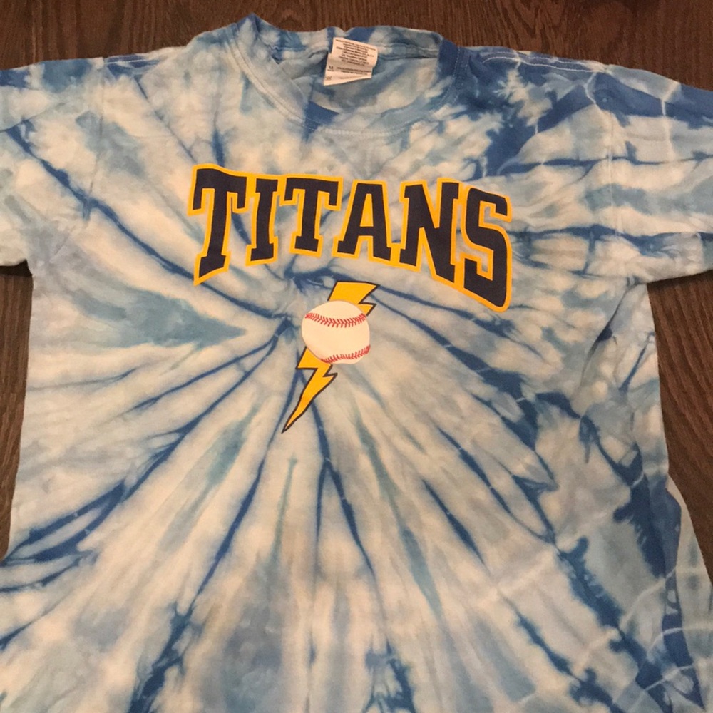 A blue tie-dyed shirt with titans on the front